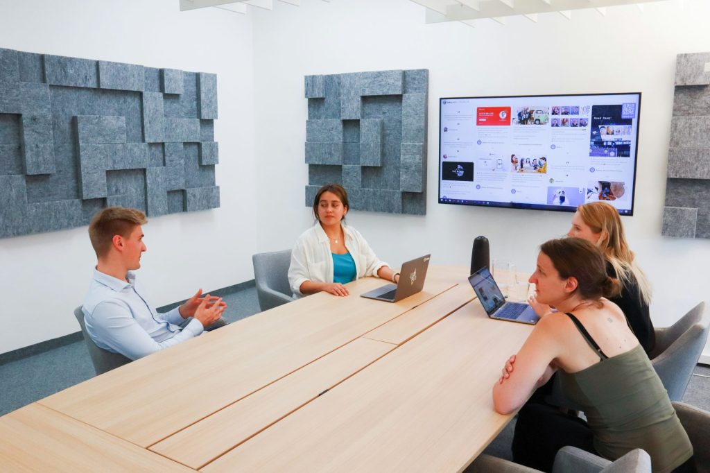 a group of people sitting around a conference table